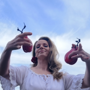 Instructor holding red castanets for the Rondo Alla Turca castanet course